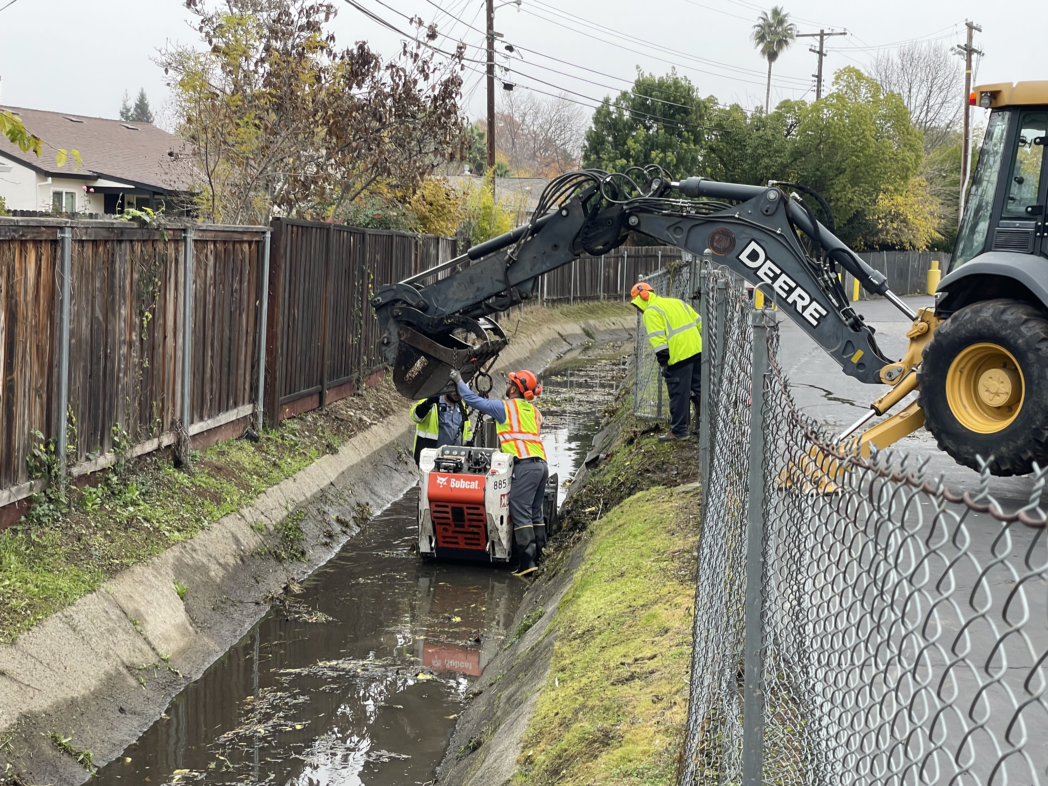Crews cleaning drainage canal