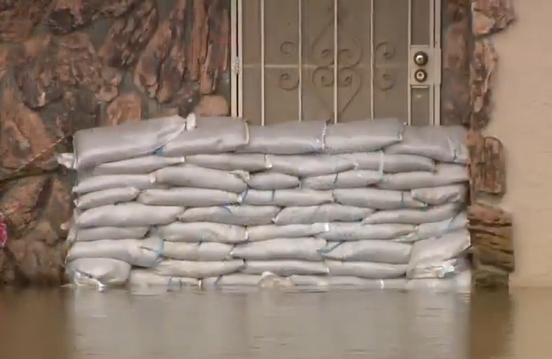 Sandbags protecting a home from flooding