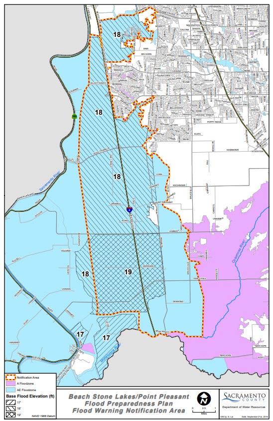 Map showing designated flood warning areas in Sacramento County, including flood elevation levels, key landmarks, and areas at risk of inundation, used to support emergency planning and public safety during high water events.